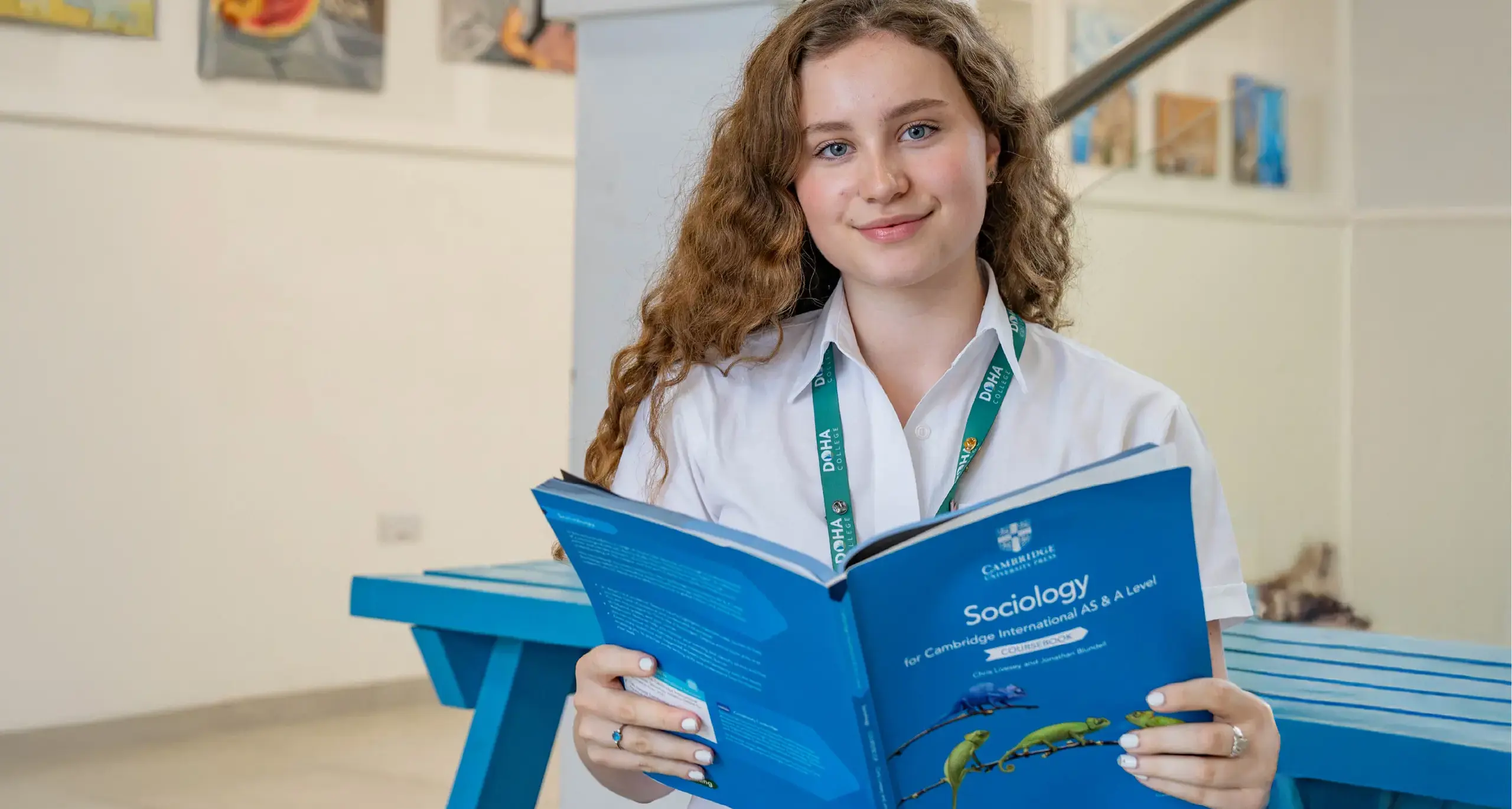 6th Form Student Reading Sociology Textbook
