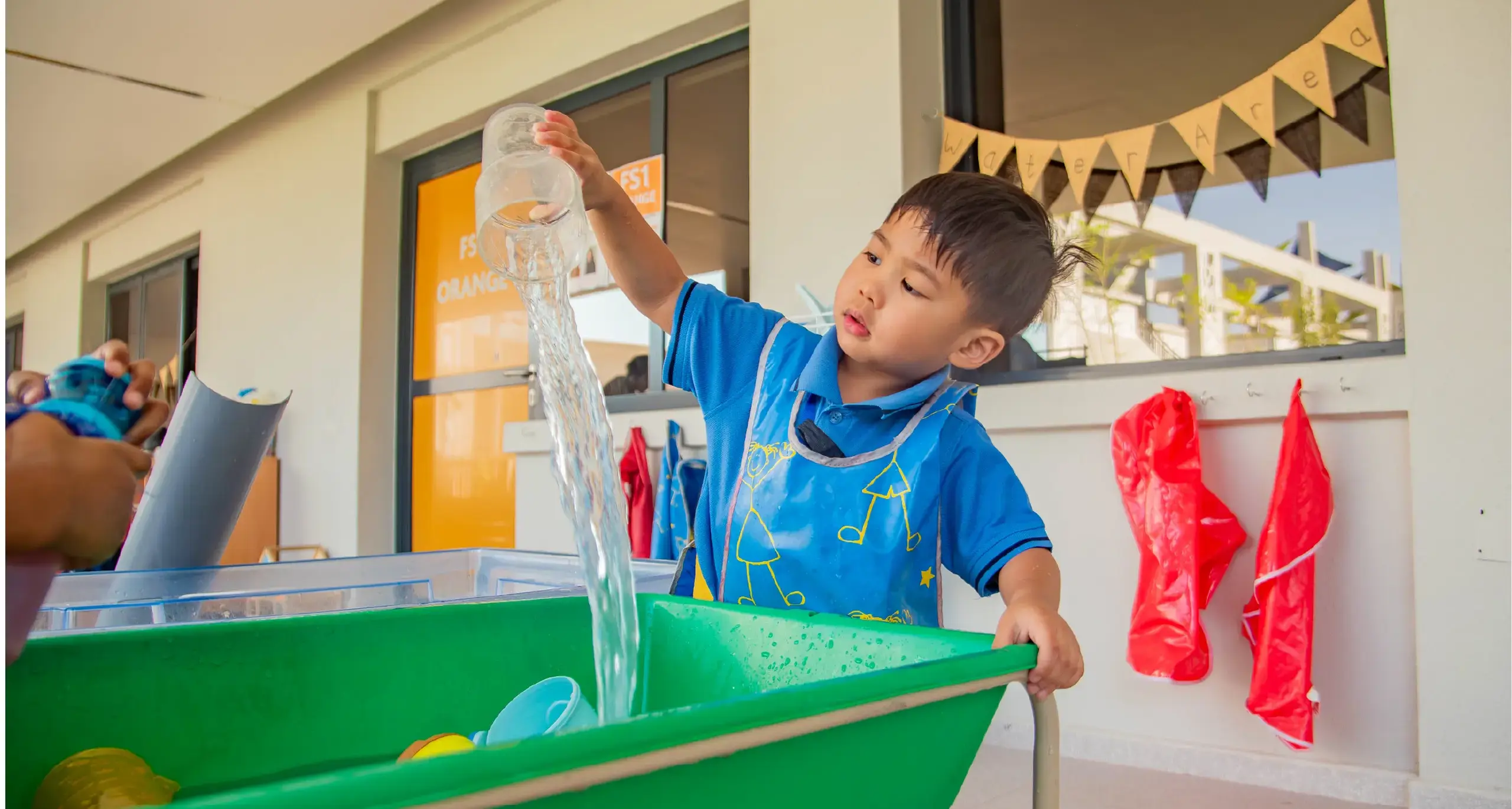 Early Years Male Student Doing Water Activities in Class