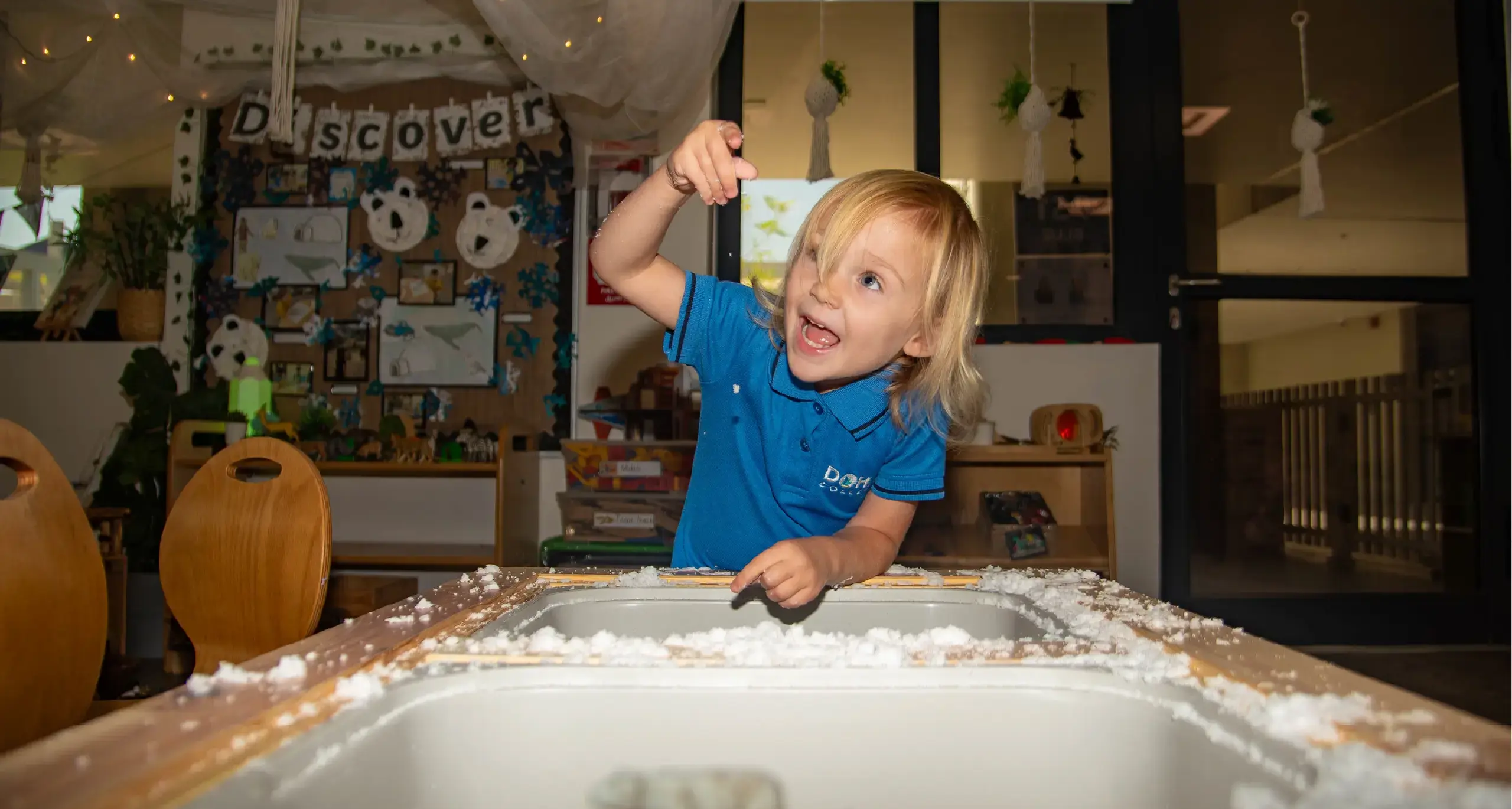 EYFS Female Student Playing with Fake Snow