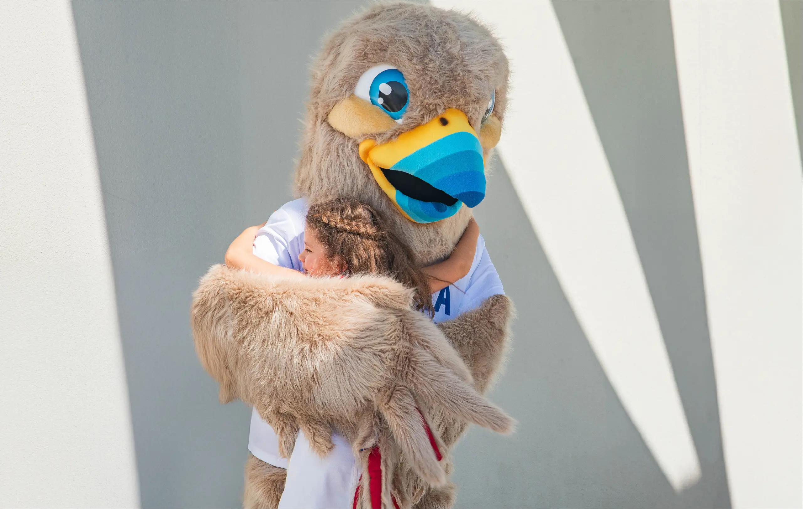 School Macot Felix Hugging Student
