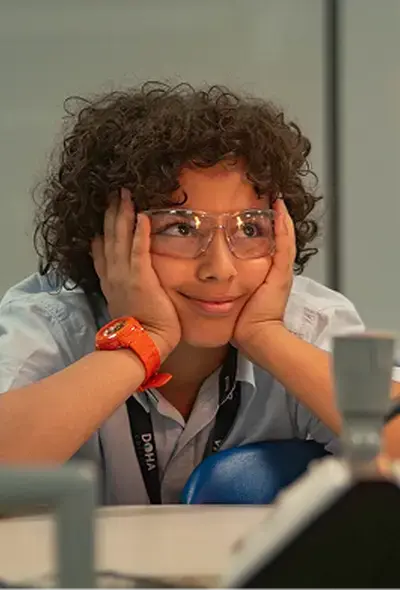 Student Listening Intently to Lesson While Wearing Safety Goggles