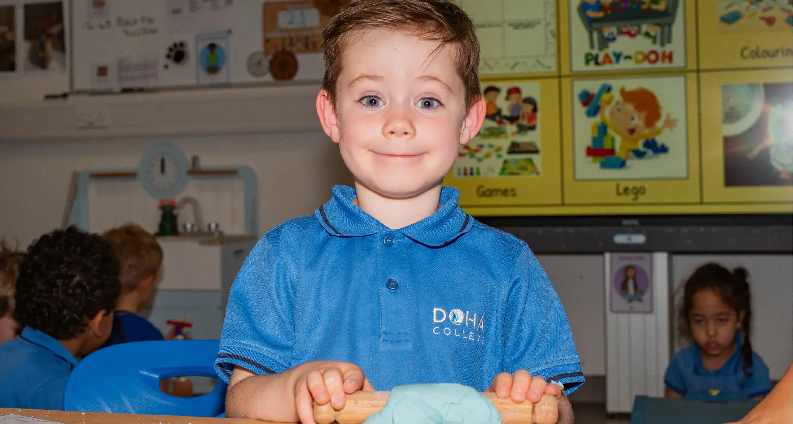 EYFS Student Rolling out Play-Doh