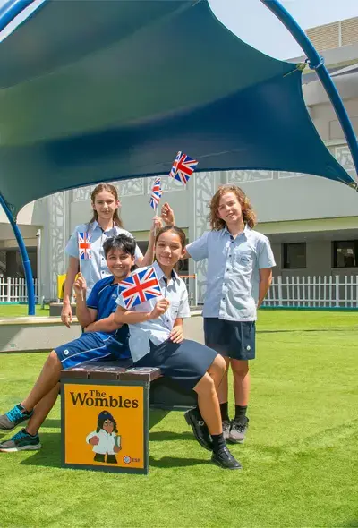 Multi-Cultural Students Holding Union Jack Flags and Smiling
