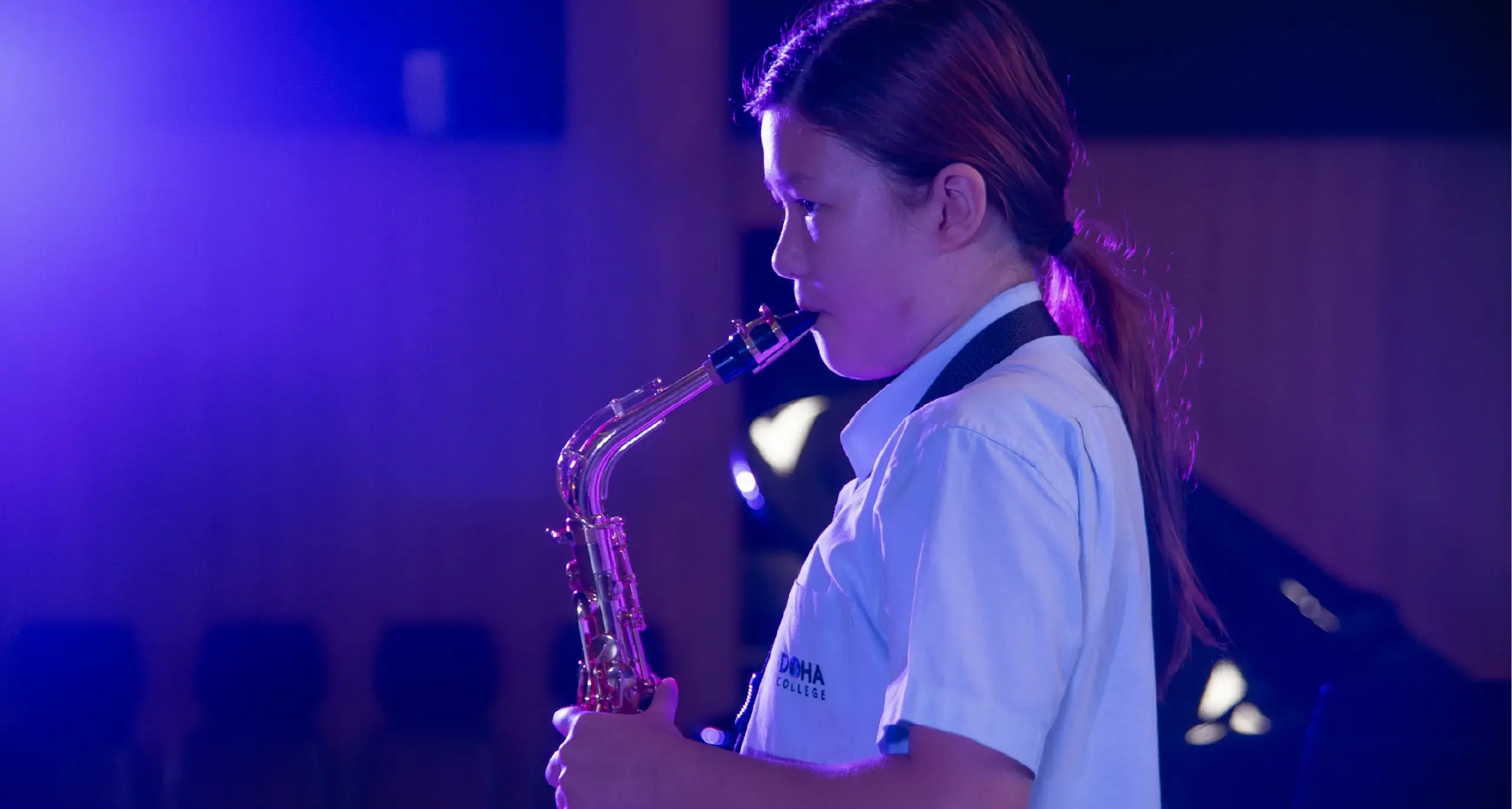 Student Playing Saxophone in Performance