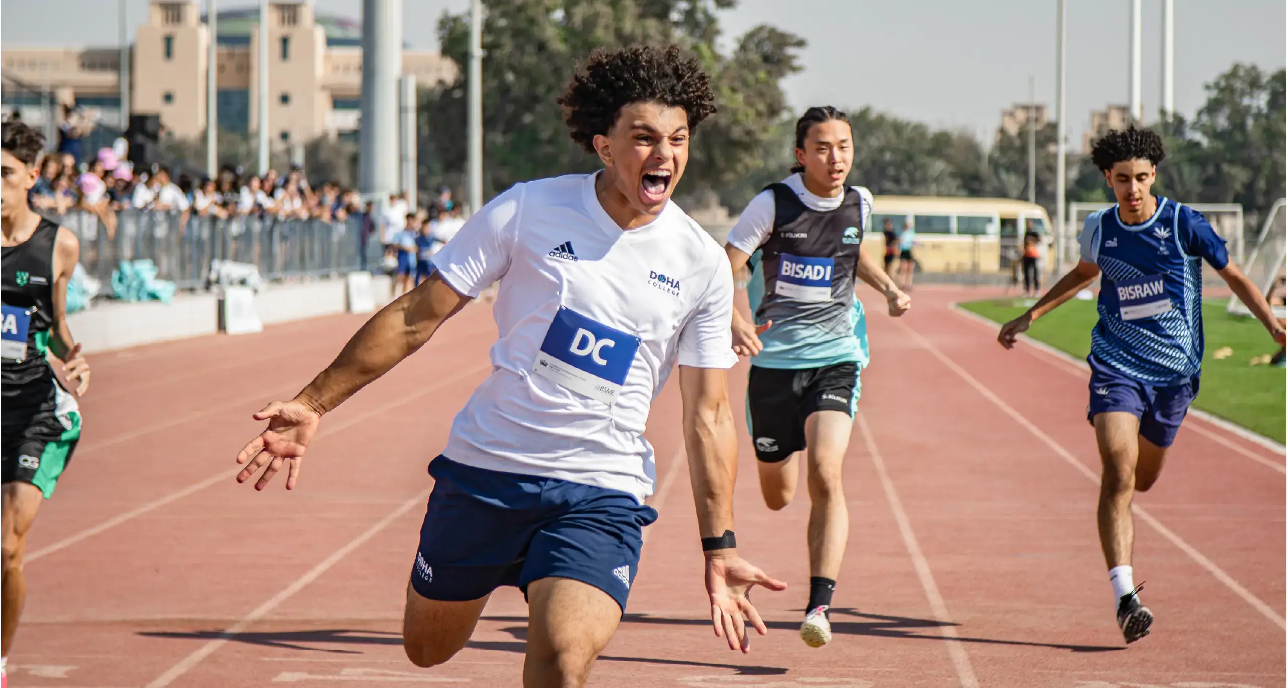 Male Students Celebrating Track and Field Win