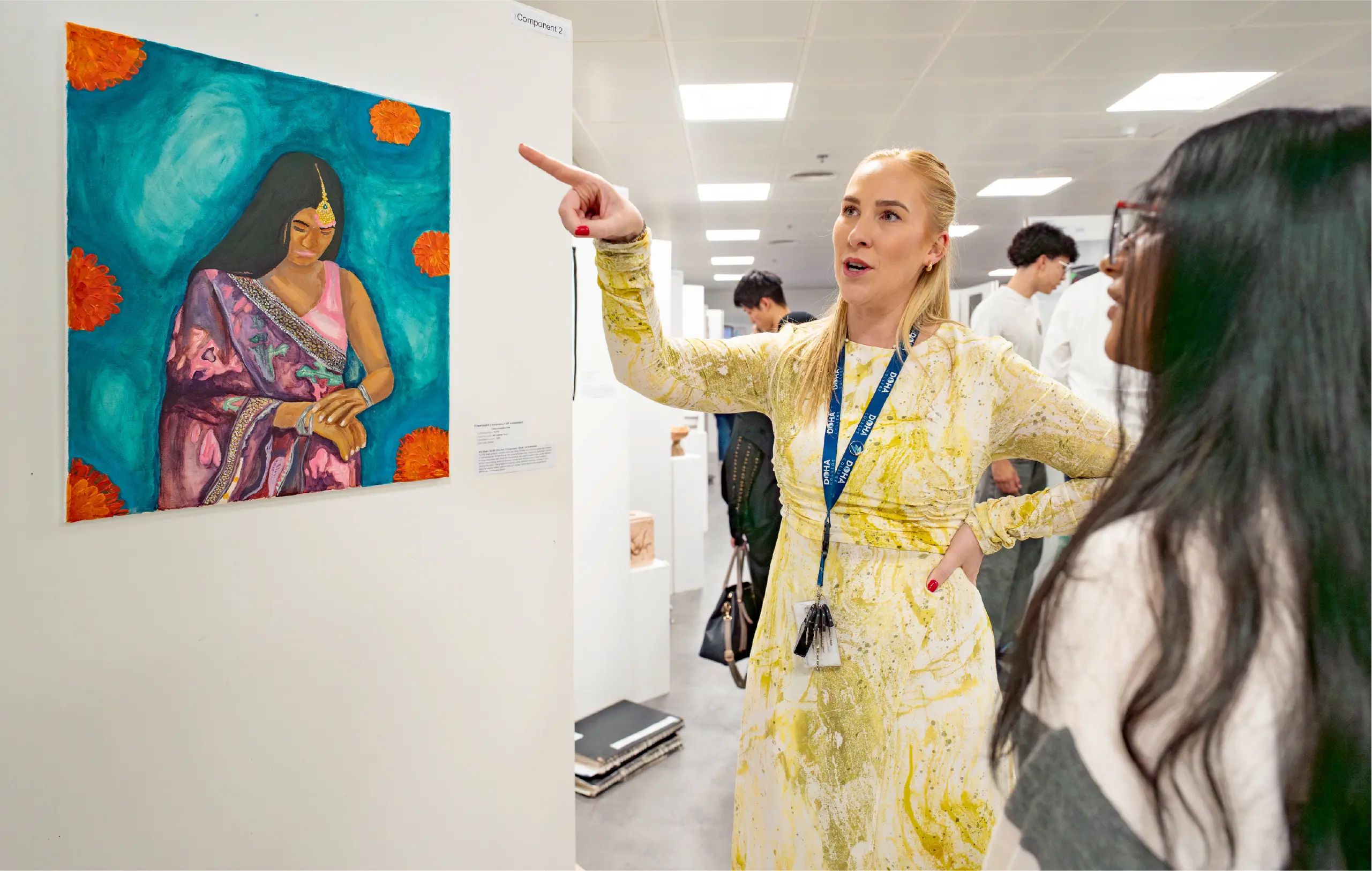 Teacher SHowing off Student Artwork